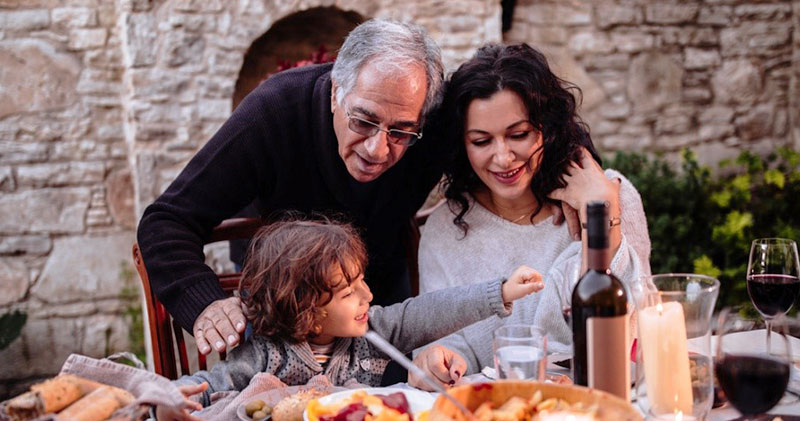 Italian family sitting at table